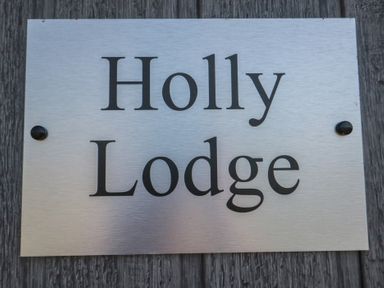 A nameplate reading Holly Lodge at Holly Lodge in Whitby