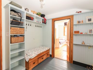 An entryway with a bench and shelves at Shanti Gher in Bantry