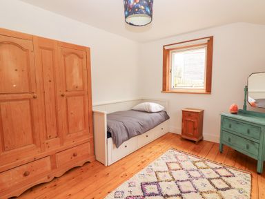A bedroom with a bed and wardrobe at Shanti Gher in Bantry