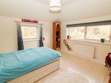 A bedroom with a bed and shelf at Shanti Gher in Bantry