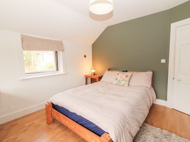 A bedroom with a bed and bedside table at Shanti Gher in Bantry