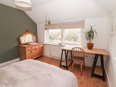 A bedroom with a bed and a desk at Shanti Gher in Bantry