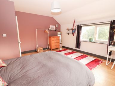A bedroom with a bed and a wooden drawer at Shanti Gher in Bantry