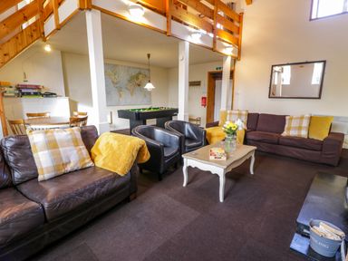 A lounge area with sofas chairs a coffee table a pool table and a dining table at Igamogam Llanllyfni near Penygroes