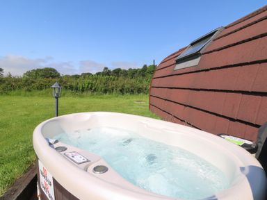 A hot tub in an outdoor space at Ty Twt Teifi in Tregaron