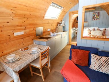 A kitchen with dining table and chairs at Ty Twt Teifi in Llanddewi-Brefi