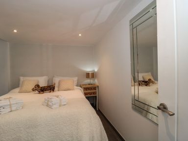 A bedroom with a bed, pillows and towels at Number 7 in Bishop Sutton