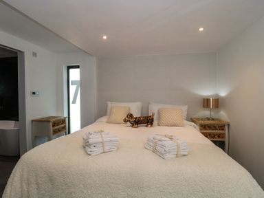 A bedroom with a bed and decorative items at Number 7 in Bishop Sutton