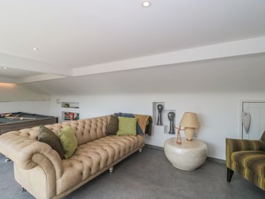 A snug with a sofa and pool table at Number 7 in Bishop Sutton