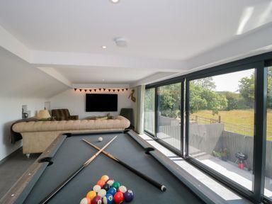 A recreation room with a pool table and a sofa at Number 7 in Bishop Sutton