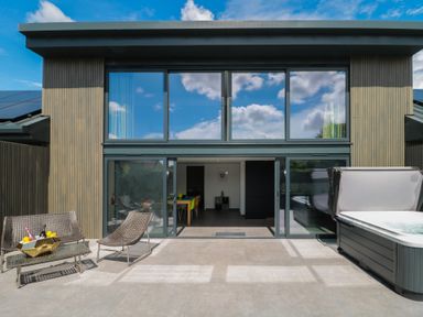 An outdoor space with chairs and a pool at Number 7 in Bishop Sutton