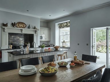 A kitchen with dining table and various food preparations at Tan Llan in Llanelltyd near Dolgellau