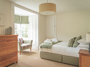 A bedroom with a bed and a sofa at Tan Llan in Llanelltyd near Dolgellau