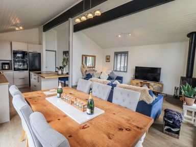 A living room with a kitchen area at Fig Tree Lodge Hutton Roof near Penrith