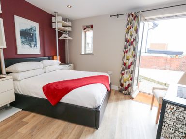 A bedroom with a bed and a window at Coastguard Lookout in Wyke Regis