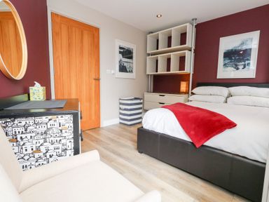 A bedroom with a bed and shelf at Coastguard Lookout in Wyke Regis