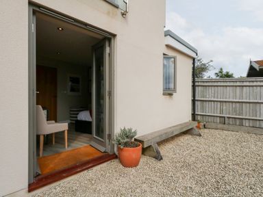 An outdoor area with a bench and potted plant at Coastguard Lookout in Wyke Regis
