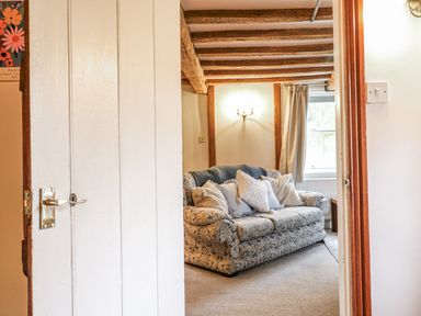 A living room with a sofa and cushions at White Gates in Banham