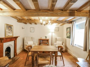 A sitting room with a wooden table and chairs at White Gates in Banham