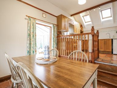 A dining room with a table and chairs at White Gates in Banham