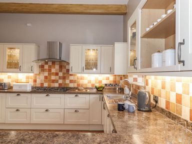 A kitchen with cabinets, sink, and appliances at The Gatehouse in 