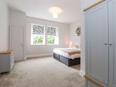 A bedroom with a bed and wardrobe at The Gatehouse
