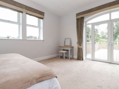 A bedroom with a bed and a table at The Gatehouse