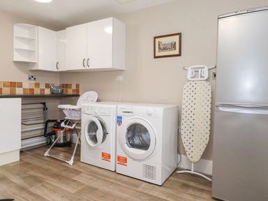 A laundry room with washing machine and dryer at The Gatehouse