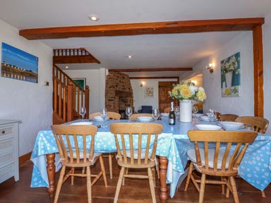 A dining room with a table and chairs at 1 Eastdon Cottages Exeter