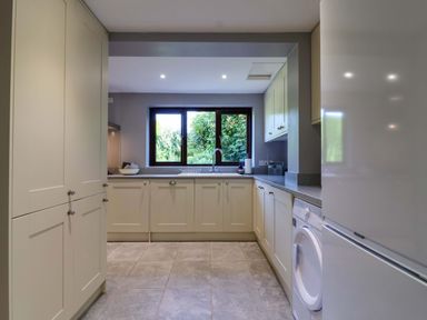 A kitchen with cabinets and a sink at 1 Eastdon Cottages Exeter