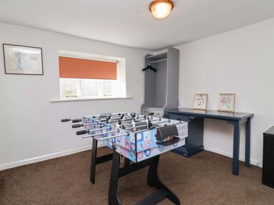 A game room with a foosball table and desk at 1 Eastdon Cottages in Exeter