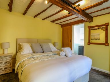 A bedroom with a bed and bedside tables at 1 Eastdon Cottages in Exeter