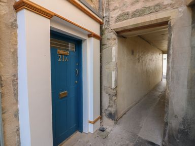 A doorway with number 21A and a pathway at 21A High Street Jedburgh
