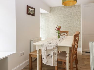 A dining room with a table and chairs at 21A High Street in Jedburgh