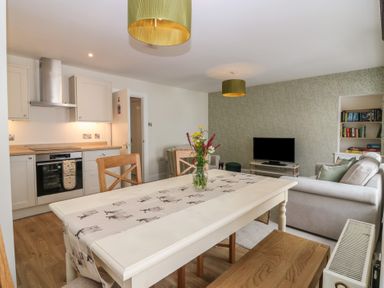 A dining area with a table and chairs at 21A High Street Jedburgh