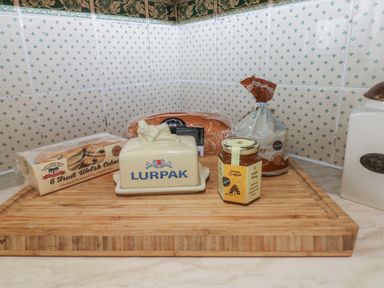 A kitchen countertop with packages of bread Welsh cakes a Lurpak butter dish and a jar of Welsh honey at Greenhaven in Narberth