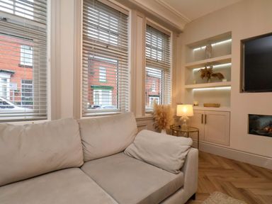 A living room with a sofa and decorative shelves at 59 Moorland Road Scarborough