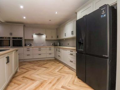 A kitchen with cabinets and appliances at 59 Moorland Road in Scarborough