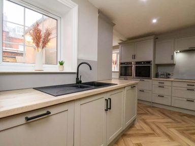 A kitchen with a sink and cabinets at 59 Moorland Road in Scarborough