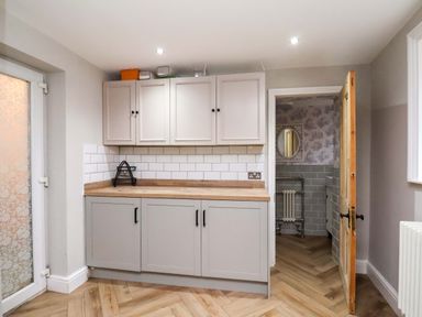 A kitchen with cabinets and a countertop at 59 Moorland Road Scarborough