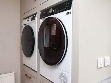A laundry room with a washing machine and dryer at 59 Moorland Road Scarborough