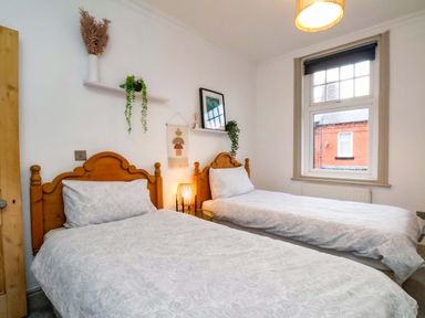 A bedroom with two beds and a window at 59 Moorland Road Scarborough