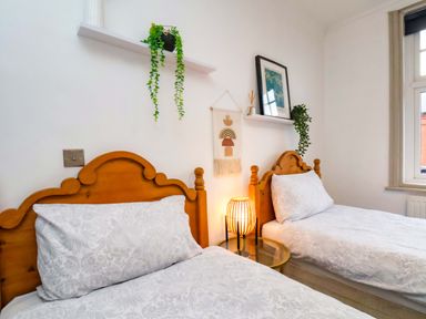 A bedroom with two beds and a lamp at 59 Moorland Road in Scarborough