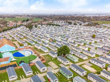 A view of multiple caravans and a swimming pool at Billy’s Way - Hayling Island