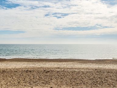 A beach with sand and ocean view at Sand and Splash - Hayling Island