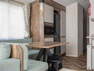 A dining area with a table and chairs at Wavecrest - Hayling Island Holiday Park