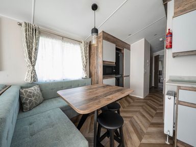 A dining area with a table and chairs at Wavecrest - Hayling Island Holiday Park