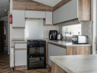 A kitchen with an oven and sink at Wavecrest - Hayling Island