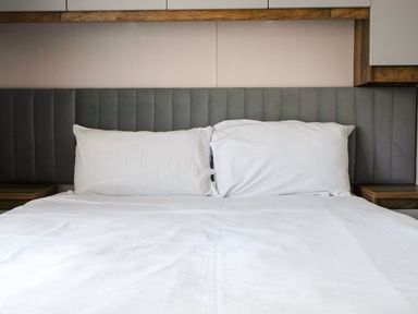 A bed with pillows and a headboard at Wavecrest - Hayling Island Holiday Park