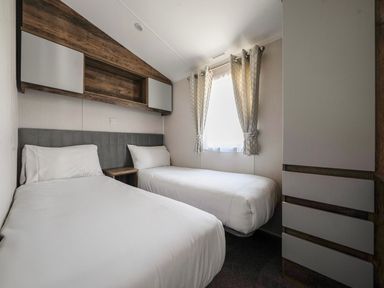 A bedroom with two beds at Wavecrest - Hayling Island Holiday Park
